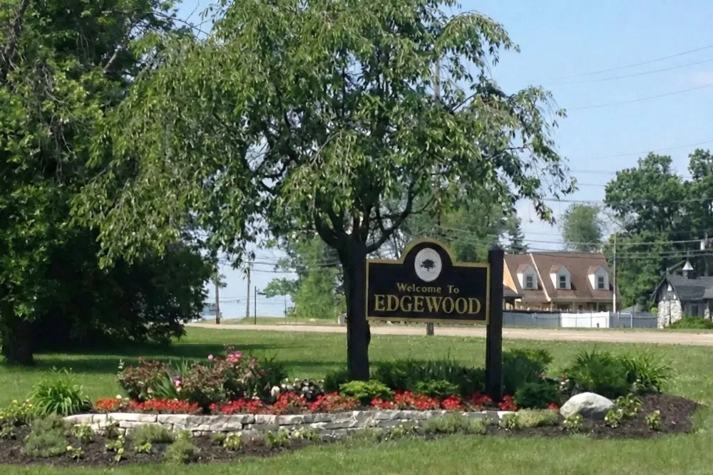 Edgewood-Kentucky 1png | Dermatology Associates of Northern Kentucky Welcome sign reading 'Edgewood' with manicured flower bed and trees in a suburban setting.