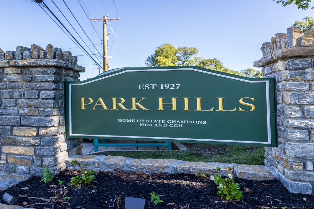 Green Park Hills sign with gold lettering reading 'PARK HILLS' and smaller text 'EST 1927' on a stone pillar entrance.